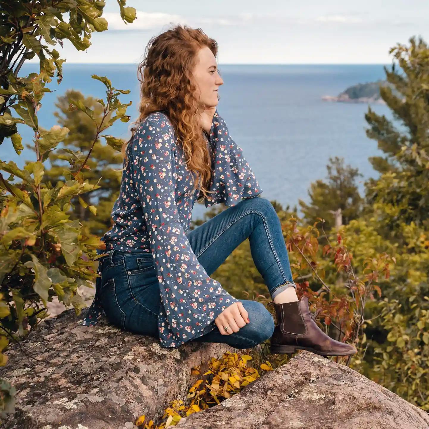 Woman sitting on a rock